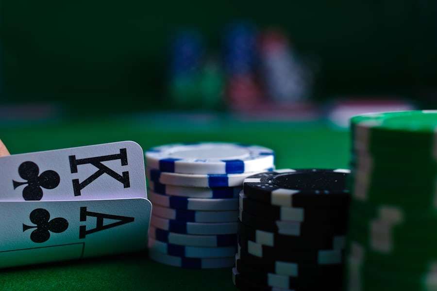 Tumpukan kartu remi dan chip poker di atas meja kain hijau